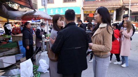 A government minder interrupts CNN's interview and pushes the interviewee away.