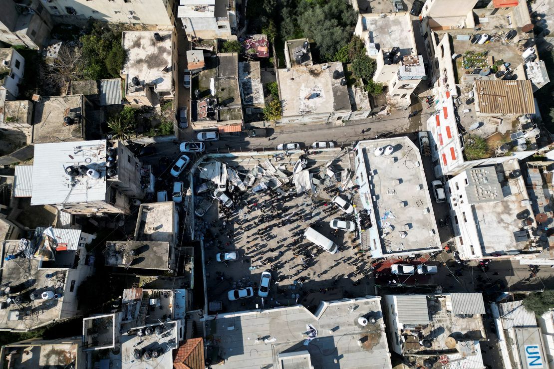 Palestinians inspect the damage following an Israeli raid in Jenin on January 26, 2023.