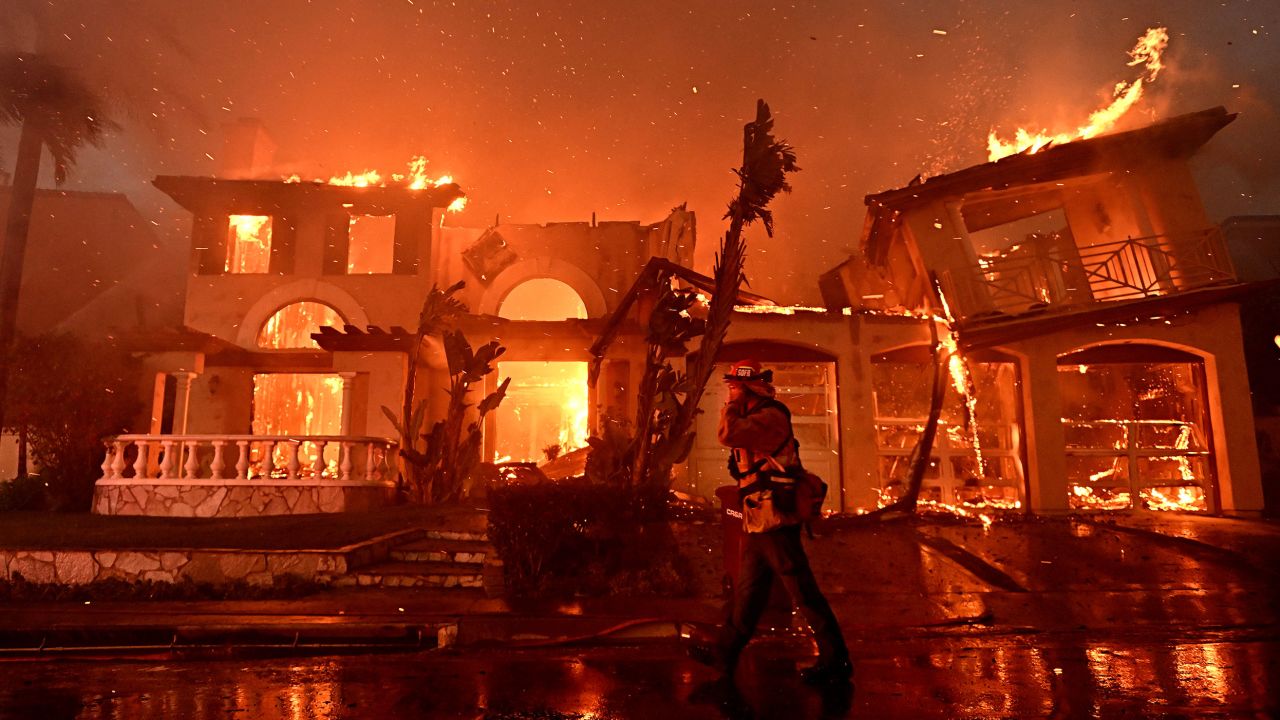 Firefighters battle a brush fire that destroyed several homes in Laguna Niguel, California, in May 2022.