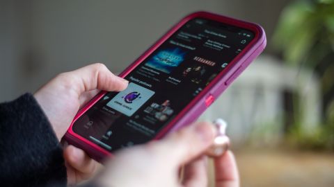A person browses true crime podcasts on their phone.