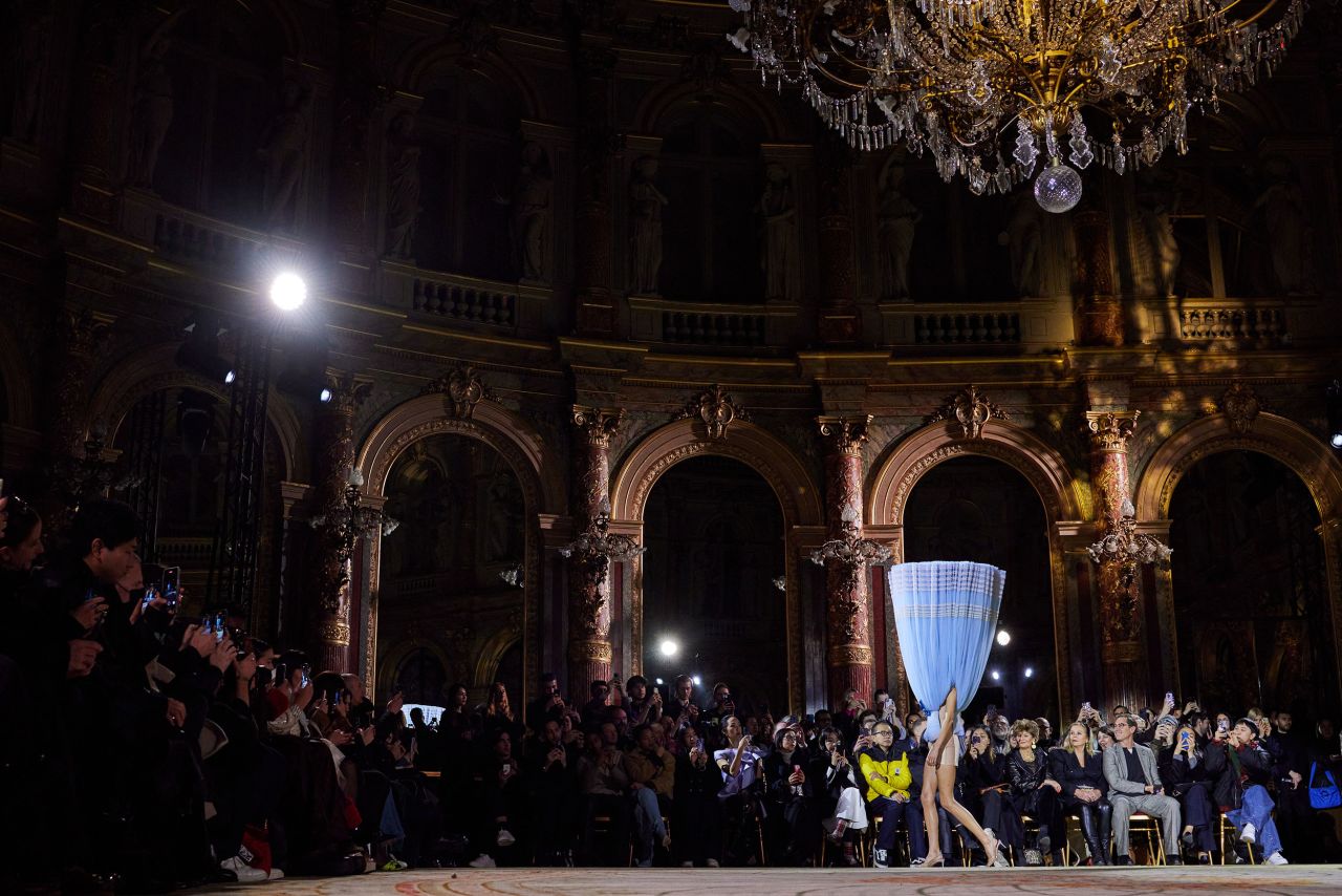 A model walks the runway during a <a href="https://www.cnn.com/style/article/viktor-and-rolf-paris-haute-couture-week/index.html" target="_blank">Viktor & Rolf couture show</a> in Paris on Wednesday, January 25. Models walked the runway in tulle princess gowns and multitiered dresses that were flipped in every direction. This one walked with a fully upside-down dress, the hemline obscuring her face and her legs emerging from the sweetheart neckline.