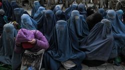 Women wearing a burqa wait for free bread in front of a bakery in Kabul on January 24, 2022. (Photo by Mohd RASFAN / AFP) (Photo by MOHD RASFAN/AFP via Getty Images)