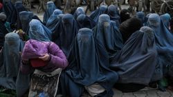 Women wearing a burqa wait for free bread in front of a bakery in Kabul on January 24, 2022. (Photo by Mohd RASFAN / AFP) (Photo by MOHD RASFAN/AFP via Getty Images)