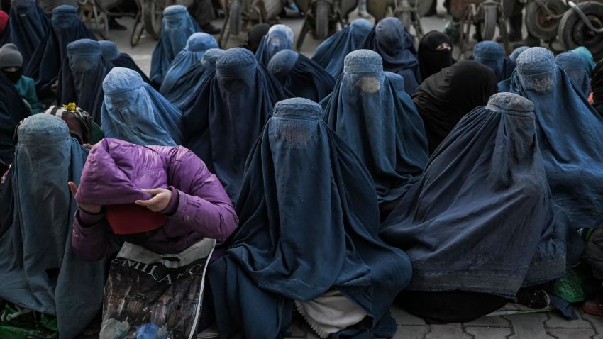 Women wearing a burqa wait for free bread in front of a bakery in Kabul on January 24, 2022. (Photo by Mohd RASFAN / AFP) (Photo by MOHD RASFAN/AFP via Getty Images)