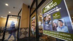 A hiring sign is displayed in the window of a Panera Bread store in Pittsburgh on Monday, Jan. 23, 2023.