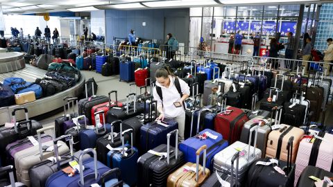 A traveler searches for a friend's suitcase in a baggage holding area for Southwest Airlines at Denver International Airport on December 28, 2022 in Denver, Colorado. 