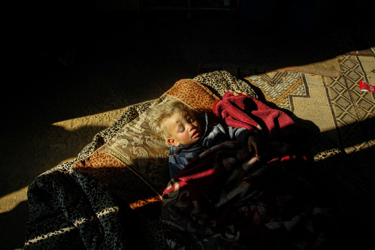 A child sleeps on the floor of a poor neighborhood in Beit Lahia, Gaza, on Tuesday, January 24. <a href=