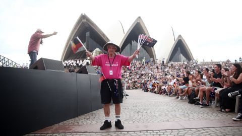 A volunteer holds the Australian and Aboriginal flags at a concert on January 26, 2023, at Sydney Opera House.