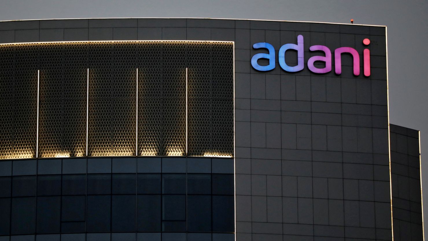 The logo of the Adani Group is seen on the facade of one of its buildings on the outskirts of Ahmedabad, India, April 13, 2021.