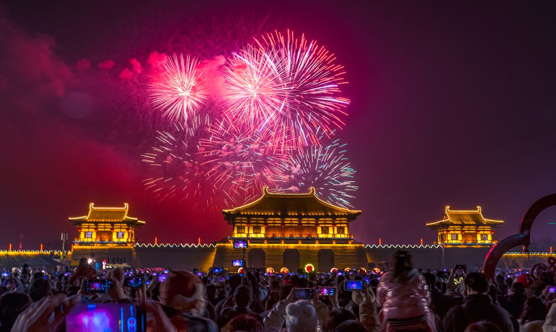 People watch a fireworks show at Dingdingmen Square to celebrate the Spring Festival on January 22, 2023 in Luoyang, China.