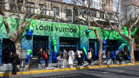 People posing for photos at a pop-up Louis Vuitton shop in Shanghai in January 2022. 