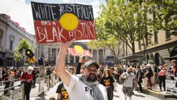 People march down Bourke street during the Invasion Day rally on January 26, 2023 in Melbourne, Australia.  