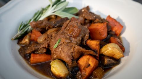 A dish of roasted vegetables and seitan, a plant-based meat substitute, is one of the recipes in Buettner's new cookbook.