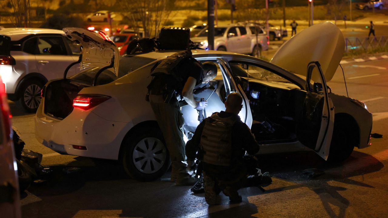 Israeli security forces search a car at the site of a reported attack in a settler neighbourhood of Israeli-annexed east Jerusalem, on January 27, 2023. 
