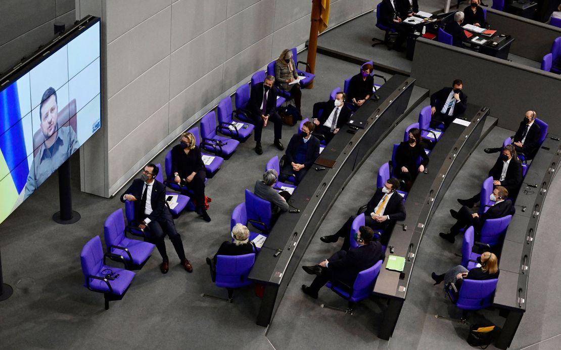 Members of the German government, among them German Chancellor Olaf Scholz (back right), listen as Ukrainian President Volodymyr Zelensky addresses them via videolink in the German lower house of parliament on March 17, 2022 in Berlin.
