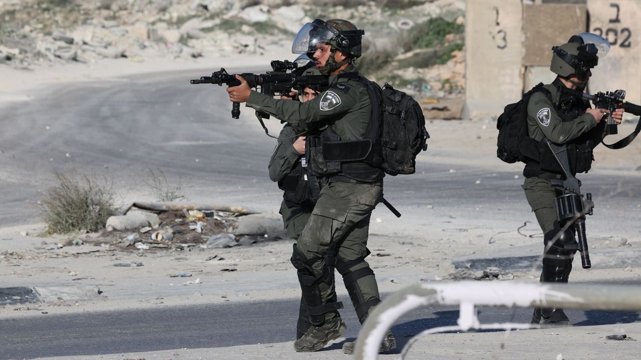 Israeli troops aim their weapons during confrontations with Palestinian demonstrators in the West Bank town of Al-Ram on January 27, 2023, following a fatal Israeli raid on the Jenin refugee camp.