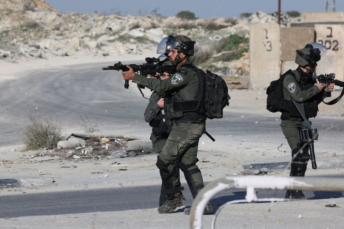 Israeli troops aim their weapons during confrontations with Palestinian demonstrators in the West Bank town of Al-Ram on January 27, 2023, following a fatal Israeli raid on the Jenin refugee camp.