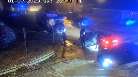 In this still from video released by the City of Memphis, officers stand around as Tyre Nichols leans up against a car after being detained and beaten on January 7.