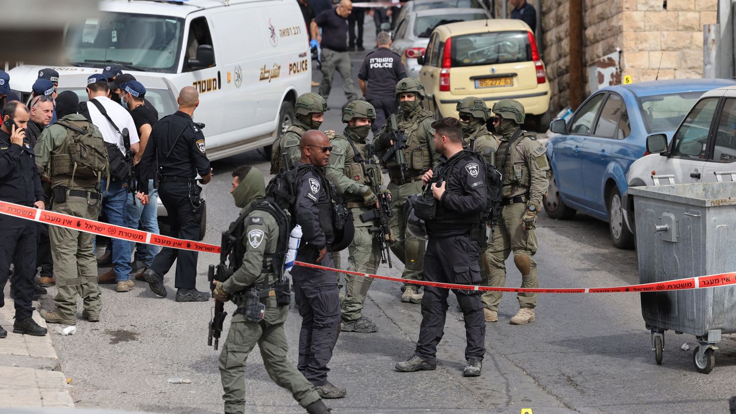 Israeli security forces and emergency services personnel gather at a cordoned-off area near the scene of Saturday's attack in Jerusalem.