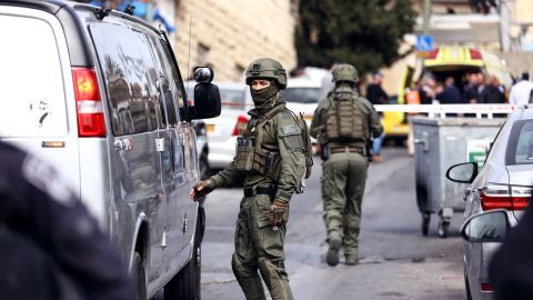 Israeli security personnel work near the scene of Saturday's shooting. 