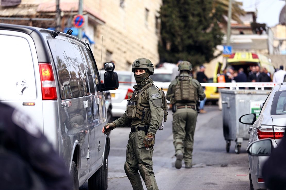 Israeli security personnel work near the scene of Saturday's shooting. 