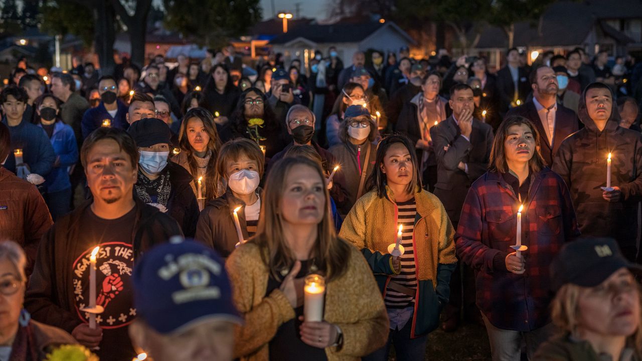 People gather at the Monterey Park City Hall for a candlelight vigil honoring 11 victims of a mass shooting in the city on Lunar New Year's Eve. 