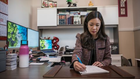 Attorney Elizabeth Yang, who took weekly classes at the Star Ballroom Dance Studio, works in her office. 