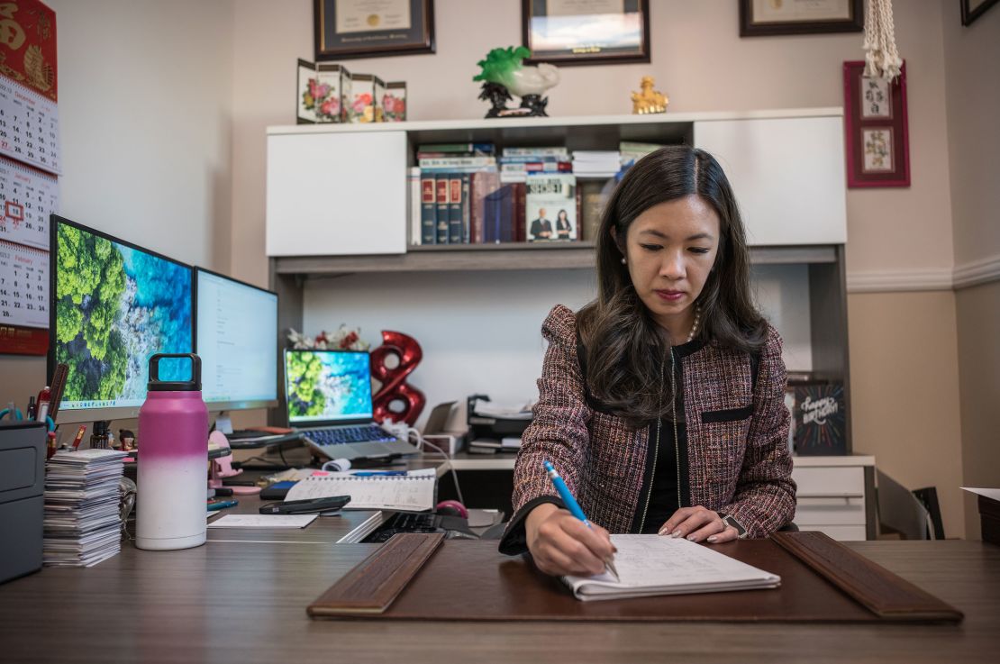 Attorney Elizabeth Yang, who took weekly classes at the Star Ballroom Dance Studio, works in her office. 