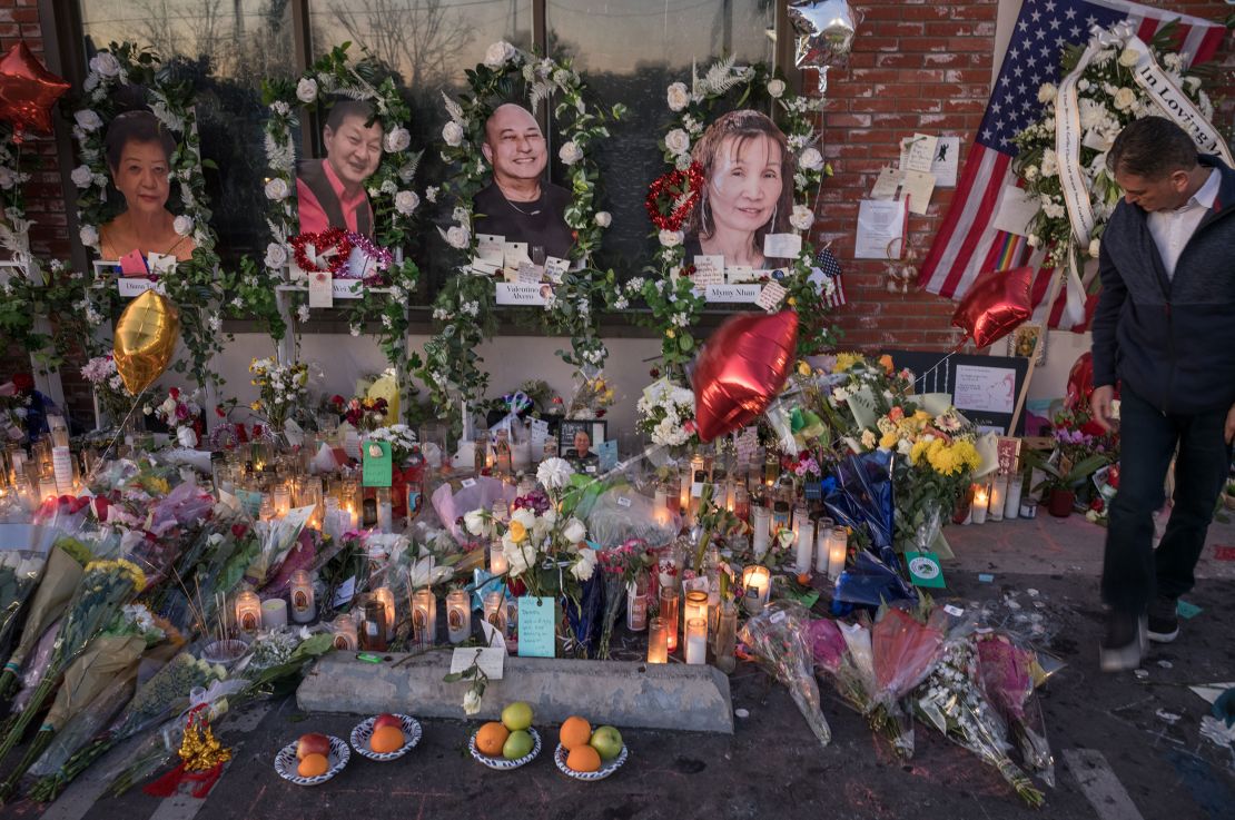 Pictures of some of the shooting victims overlook a growing memorial outside the dance hall.
