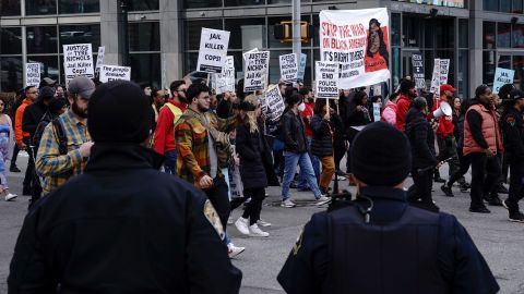 Atlanta police officers keep an eye on marchers during a rally on January 28 protesting the fatal police assault of Tyre Nichols.