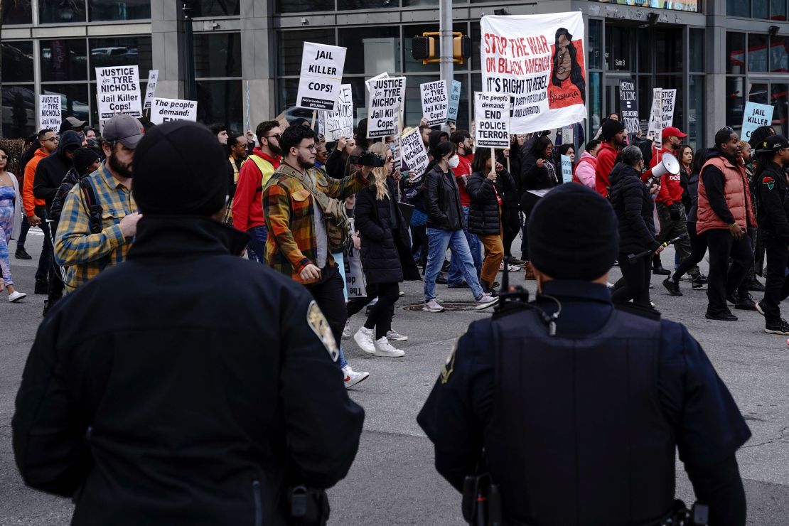 Atlanta police officers keep an eye on marchers during a rally on January 28 protesting the fatal police assault of Tyre Nichols.
