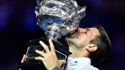 Serbia's Novak Djokovic celebrates with the Norman Brookes Challenge Cup trophy following his victory against Greece's Stefanos Tsitsipas in the men's singles final match on day fourteen of the Australian Open tennis tournament in Melbourne on January 29, 2023.
