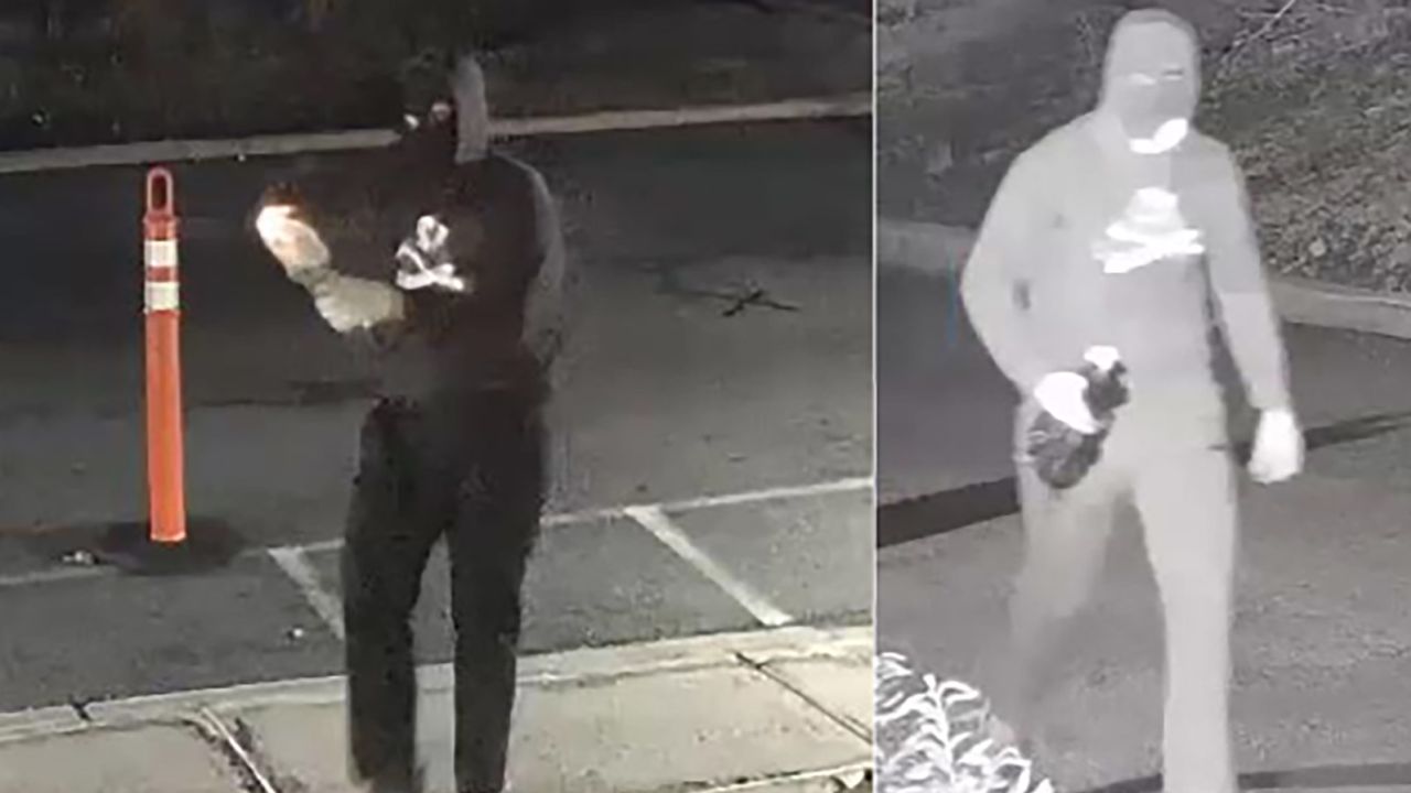 A masked suspect is seen lighting a Molotov cocktail in front of Temple Ner Tamid in a still image from surveillance footage in Bloomfield, New Jersey, on Sunday.