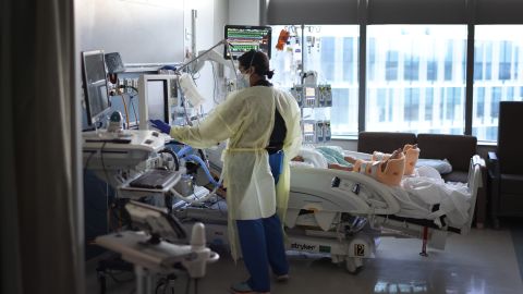 CHICAGO, ILLINOIS - JANUARY 31: Respiratory Therapist Nirali Patel works with a COVID-19 patient in the ICU at Rush University Medial Center on January 31, 2022 in Chicago, Illinois. Respiratory therapists work with physicians and nurses to help patients restore and maintain normal lung capacity and blood/oxygen levels. After two years, the COVID-19 pandemic has contributed to an estimated 1,000,000 American deaths. 