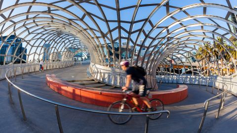 A cyclist rides on the Webb Bridge in Docklands, Melbourne. Spanning the Yarra River, the bridge is only for cyclists and pedestrians.