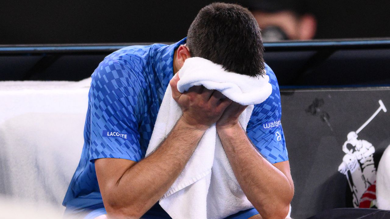 Djokovic cries into his towel after victory. 