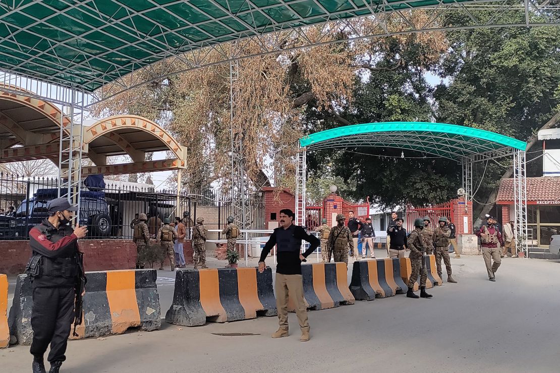 Security personnel stand guard outside police headquarters after the blast in Peshawar.