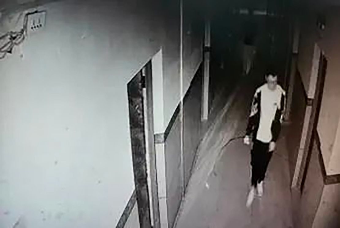 This screengrab from surveillance camera footage shows Hu Xinyu walking down a hallway in his dormitory.