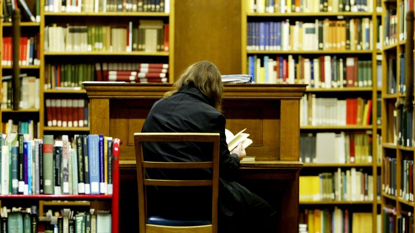 LONDON - DECEMBER 1:  A student studies in the main library at the University College London on December 1, 2003 in London. British Prime Minister Tony Blair faces mounting revolt from MPs following legislation proposals  announced by the Queen in her speech to Parliament to allow universities treble their fees.  (Photo by Ian Waldie/Getty Images)