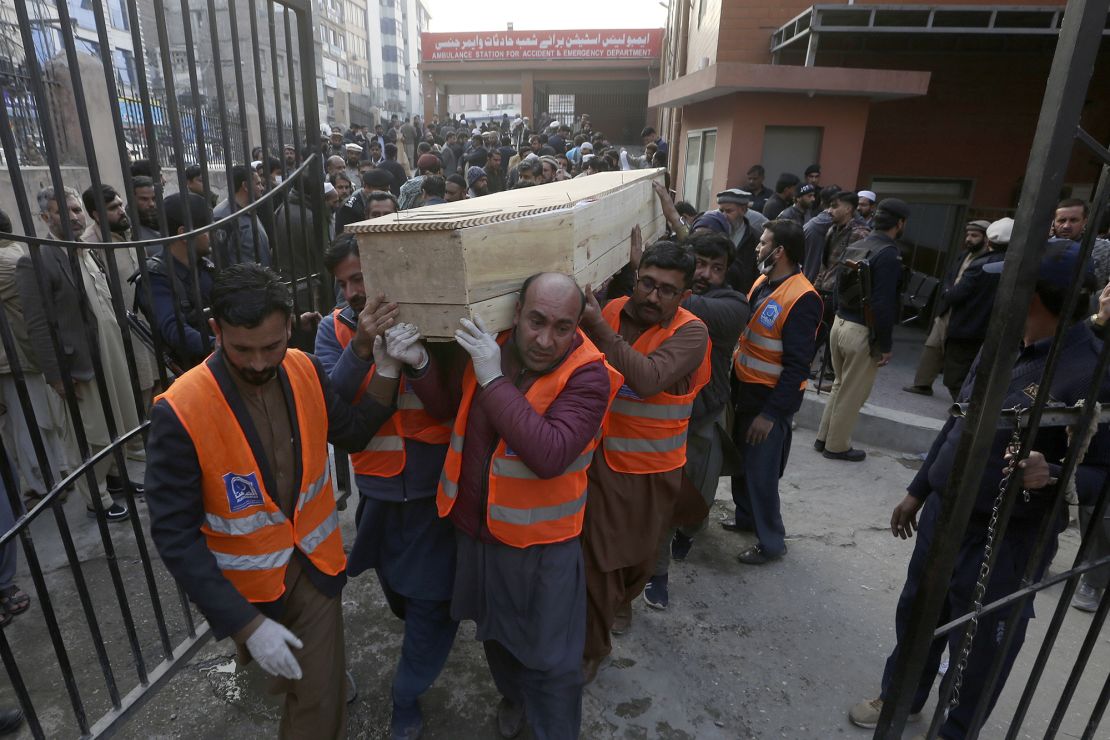 Volunteers carry the coffin of a man killed in Monday's mosque attack.