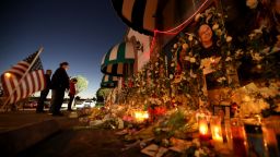 MONTEREY PARK, CA -  JANUARY 26, 2023 - - People pay their respects at the memorial for 11 people who died in a mass shooting during Lunar New Year celebrations outside the Star Ballroom Dance Studio in Monterey Park on January 26, 2023. (Genaro Molina / Los Angeles Times via Getty Images)