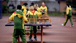 08 December 2018, China, Sichuan, Dujiangyan: Students of the Youai school play table tennis.