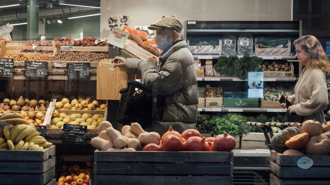 Customers shop for groceries inside a grocery store in Paris, France on Jan. 2, 2023.