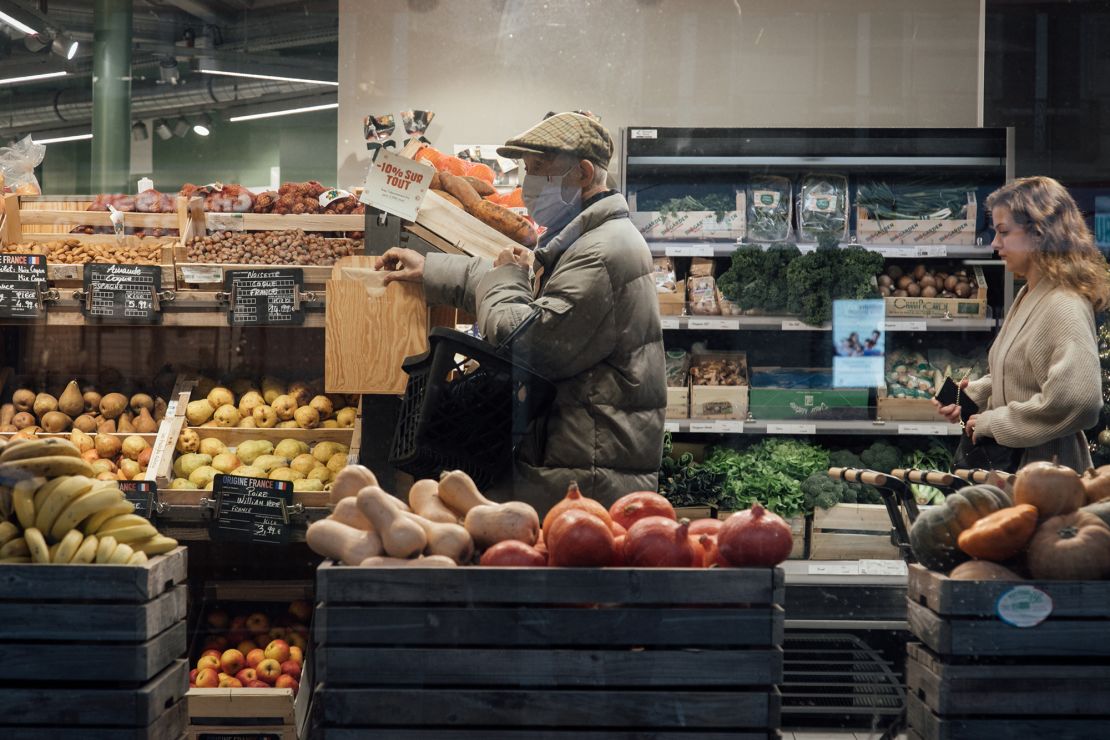 Customers shop for groceries inside a grocery store in Paris, France on Jan. 2, 2023.