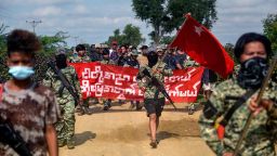 Anti-coup fighters escort protesters as they take part in a demonstration against the military coup in Sagaing, in the Sagaing Division of Myanmar on September 7, 2022. - In Myanmar's northwest Sagaing region, dozens of local "Peoples Defence Forces" are fighting the military and attempting to overturn the coup it carried out last year. Armed with little more than homemade weapons and knowledge of the local terrain, some of these groups have surprised the military with their effectiveness, analysts say. - TO GO WITH 'MYANMAR-CONFLICT-COUP' (Photo by AFP) / TO GO WITH 'MYANMAR-CONFLICT-COUP' (Photo by STR/AFP via Getty Images)