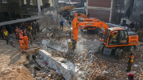 Security personnel and rescue workers search for victims after Monday's blast at a mosque in Peshawar, Pakistan.