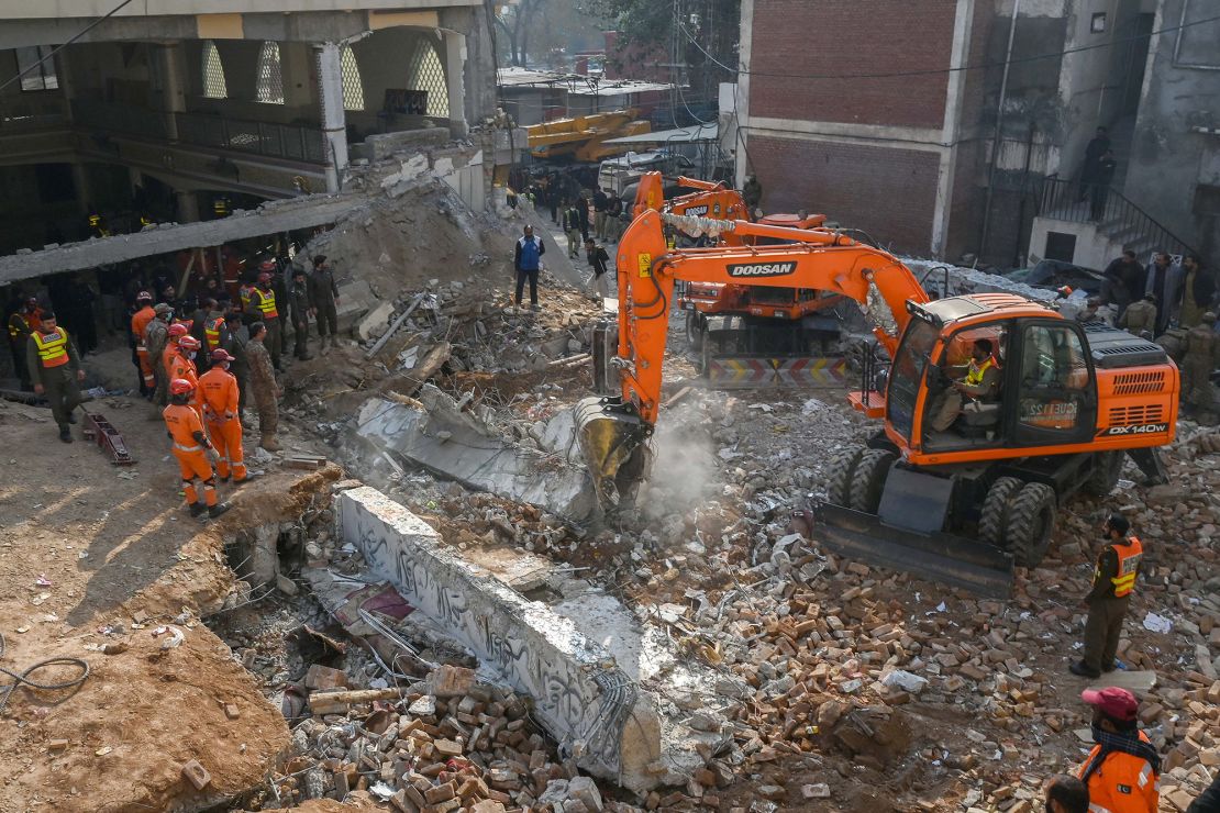 Security personnel and rescue workers search for victims amid the debris of the destroyed mosque on Tuesday.
