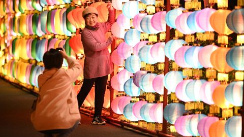 NANNING, CHINA - JANUARY 28, 2023 - Visitors take photos of a Chinese Lunar New Year "lantern wall" at a park in Nanning, South China's Guangxi Zhuang autonomous region, Jan 28, 2023. In a park, lanterns from all over the world gather together in a hundred-meter "lantern wall" corridor, with a variety of colorful lighting styles. The lantern wall is a little mysterious, colorful lanterns arranged into the wall. (Photo credit should read CFOTO/Future Publishing via Getty Images)