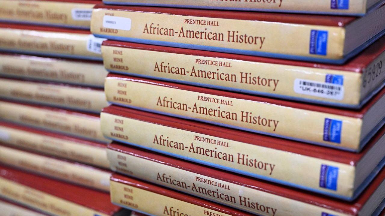 Books are piled up at a classroom in Aurora, Colorado, where students are taking part of a pilot version of the AP African American Studies course. 