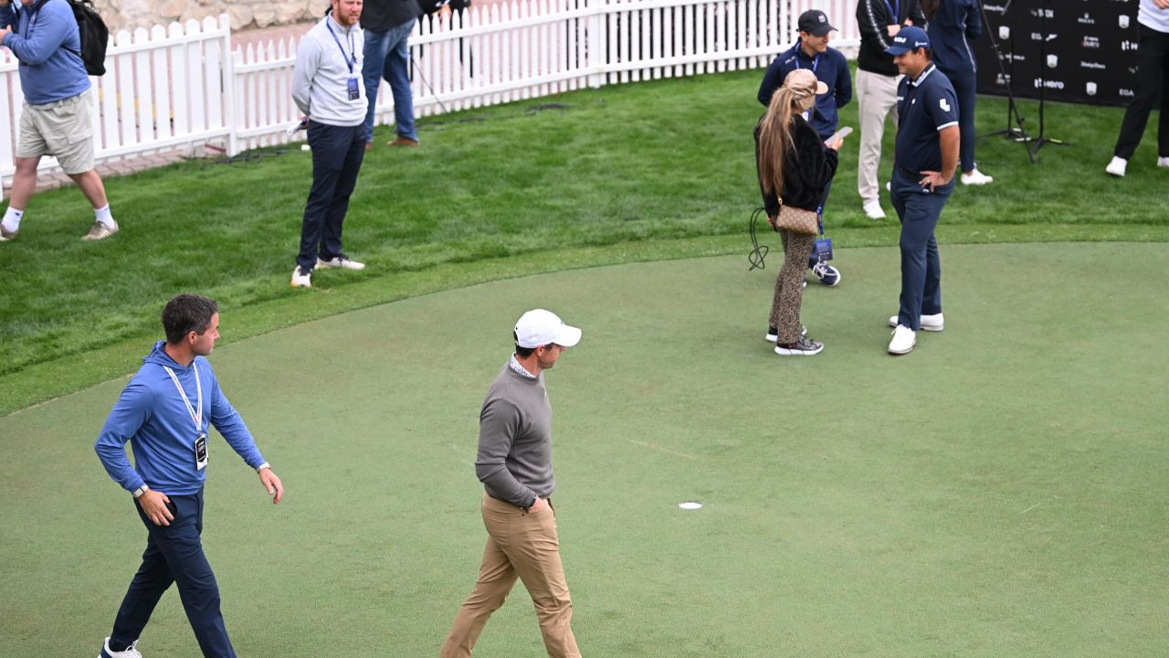 McIlroy walks past Reed on day two of the Hero Dubai Desert Classic.